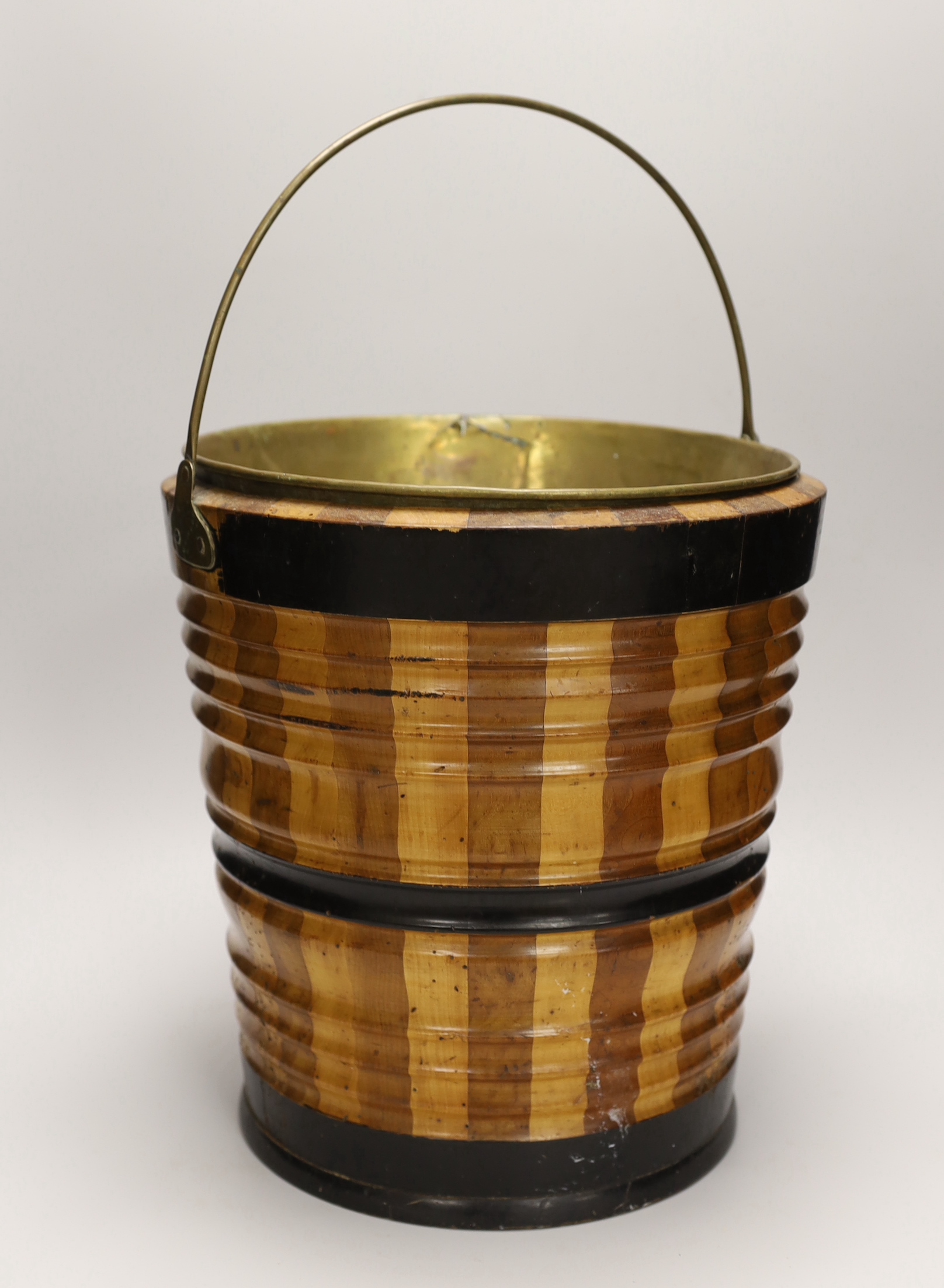 A 19th century Dutch maple and walnut oyster bucket or jardiniere with later brass liner, 32cm high